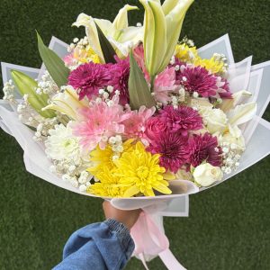 Mixed flower bouquet with pink roses, lilies and colourful chrysanthemums