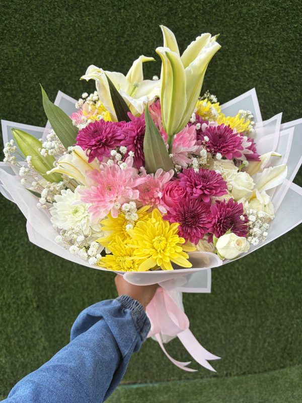 Mixed flower bouquet with pink roses, lilies and colourful chrysanthemums